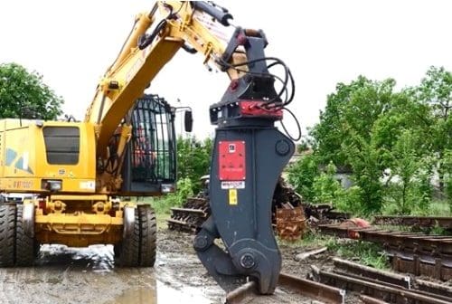 An image of a railroad shear picking up beams